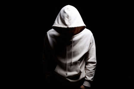 Man in Hood. Boy in a hooded sweatshirt. Male portraitの写真素材