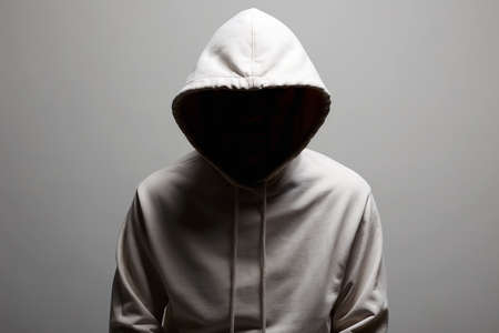 Man in Hood. Boy in a hooded sweatshirt. Face in dark
