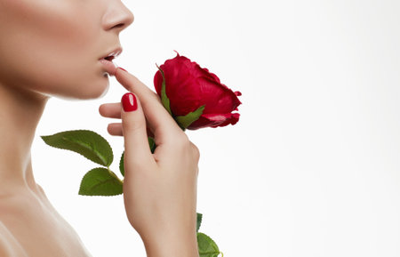 Beautiful Young Woman with Flower. Sensual Beauty Portrait of girl with Rose Flower. Clean Face, Make-up, manicure, careの写真素材
