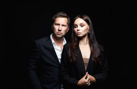 beautiful woman with handsome man in suit. Couple. Adorable, elegant girl seducing her handsome...