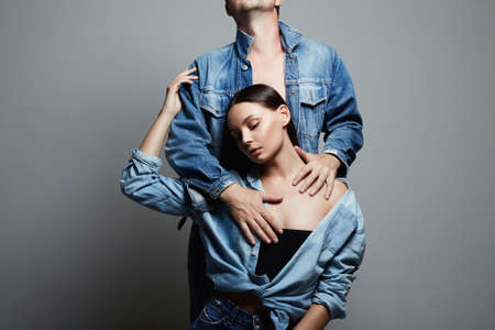 lovely beautiful couple. sexy woman and man. boy and girl together. jeans styleの写真素材