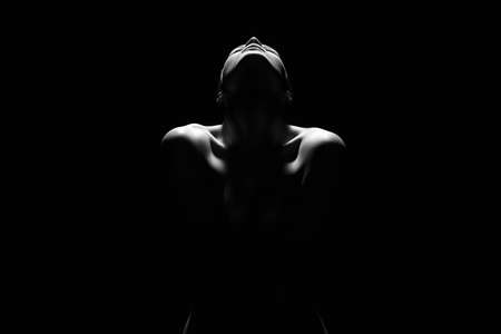 Nude Young Woman silhouette in the dark. Beautiful Sexy Naked Body Girlの写真素材