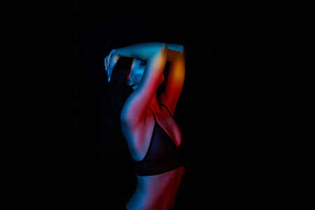 Sexy woman in Underwear. Beautiful Girl in Rainbow color lightsの写真素材