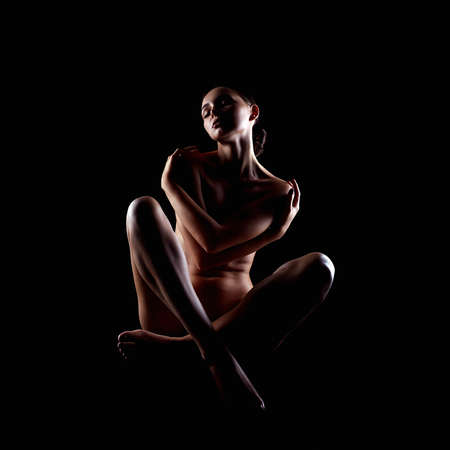 Nude Woman silhouette in the dark. Beautiful Sexy Naked Body Girlの写真素材