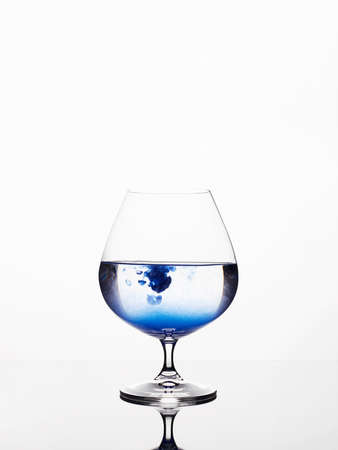blue liquor in glass. beautiful still life. Wineglasses on the mirrorの写真素材