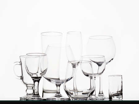 Different Empty glasses on a white background. beautiful still life of alcohol glasses collection. art posterの写真素材