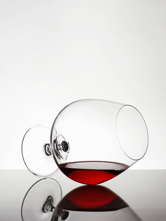 Glass with red wine or cognac. beautiful still life. Wineglass on the Table