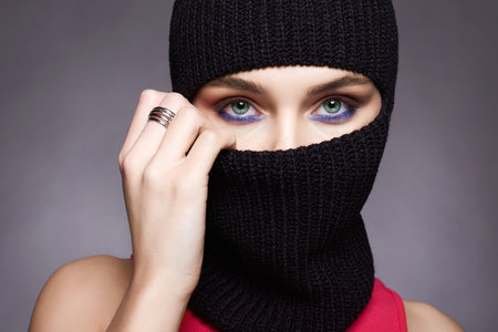 beautiful girl in black balaclava. Trendy Mask on pretty woman. new hat styleの写真素材