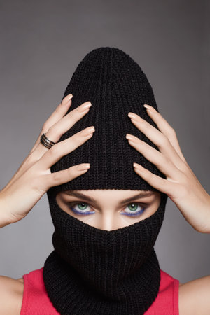 beautiful girl in black balaclava. Trendy Mask on pretty woman. new hat styleの写真素材