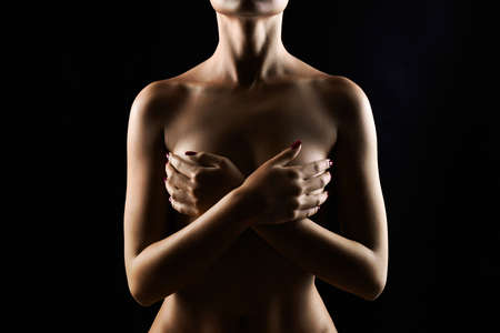 Nude Woman silhouette under light in the dark. Beautiful Sexy Naked Body Girlの写真素材