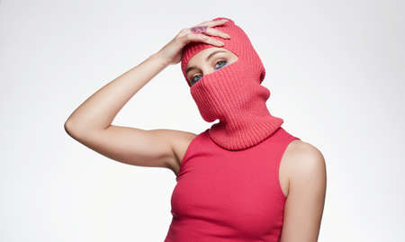 beautiful girl in red balaclava. Trendy Pink Mask on pretty womanの写真素材