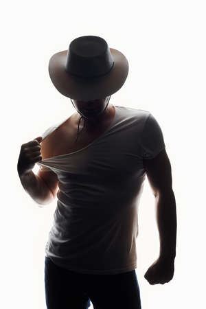 Cowboy. Silhouette portrait of a man in Hat. boy in white lightの写真素材