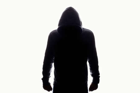 man in hood silhouette. Boy in a hooded sweatshirt Isolated on white Backgroundの写真素材
