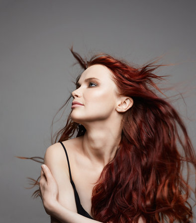 beautiful young woman with curly red hair. beauty portrait of healthy hair girlの写真素材