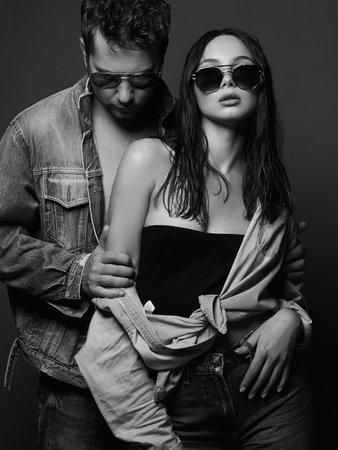 lovely beautiful couple in sunglasses. woman with handsome man. boy and girl together. jeans styleの写真素材
