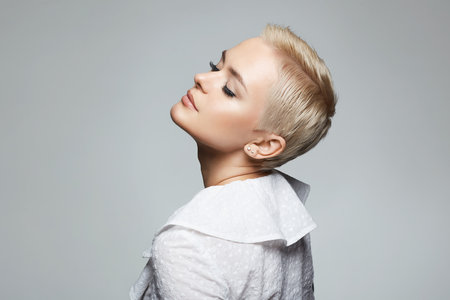 portrait of Short Hair Beautiful young woman. sensual girl with make-up and blond hair. Bald styleの素材 [FY310199402969]