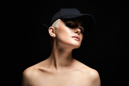 Short Hair Beautiful young woman in Hat. sensual blond girl with make-up. Bald styleの写真素材