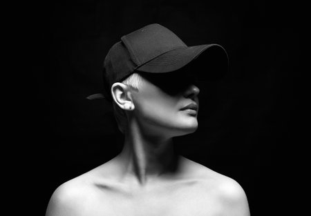 Short Hair Beautiful young woman in Hat. blonde girl with make-up. Bald style. Black and white portraitの写真素材