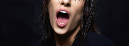 part of face. woman with open mouth. Beautiful wet Hair Ladyの写真素材