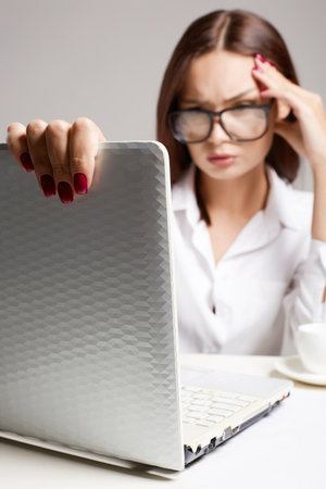 Young business woman in office. Beautiful girl in glasses. student girl with computerの写真素材