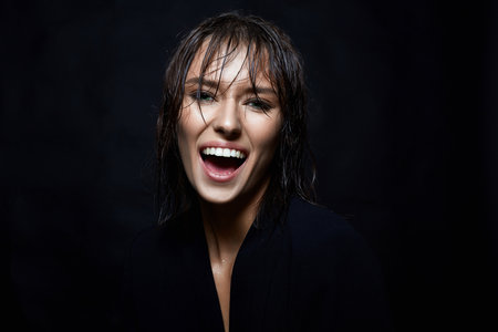 Happy smiling young woman with Wet Hair. Beautiful laughing girl. white teeth smile
