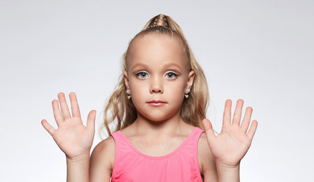 little girl in pink dress and make-up. Portrait of stylish pretty funny Child. Blondeの写真素材