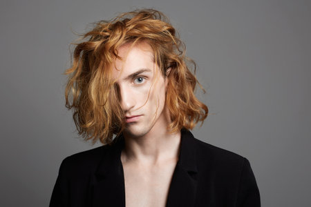 Boy with red hair. handsome young man with trendy hairstyle. Studio Portrait