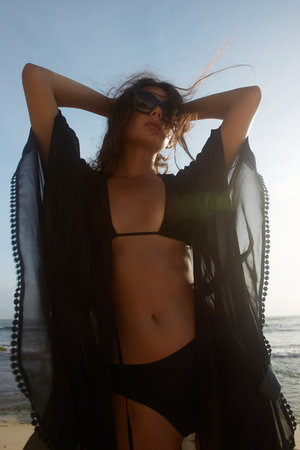 Beautiful young woman on the beach. Brunette Sexy girl in Bikini and Sunglasses. Summer vacationの写真素材