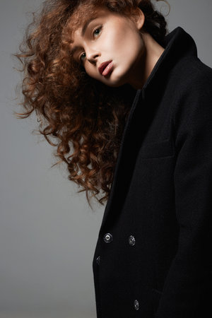 Fashion portrait of Winter style Beautiful young woman. beautiful girl with make-up and curly Hairの写真素材