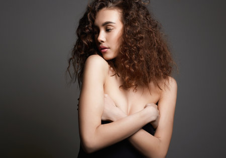 beautiful young woman with curly hair. beauty portrait of pretty girlの写真素材