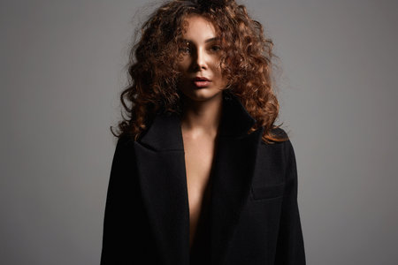 Fashion close-up portrait of Winter style curly young woman. sensual girl with make-up and curls Hairの写真素材
