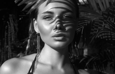 beautiful summer girl. young woman in bikini under palm tree. Black and white Portraitの写真素材