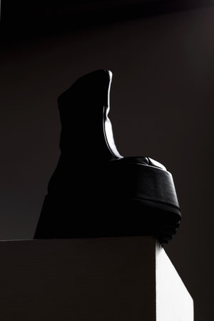 Futuristic shoes in dark. fashion art still life. cosmic black boot on cubeの写真素材