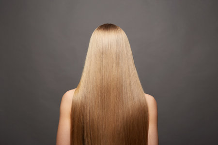 beautiful blond hair woman. Back of girl with Healthy hair. Care and straightening hairの写真素材