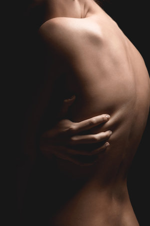 Body silhouette. Woman in dark. Beautiful sexy backの写真素材