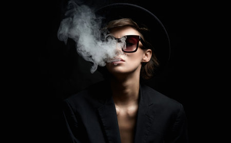Smoking Beautiful woman in sunglasses and Hat. beauty Lady in suit releasing smoke from mouth