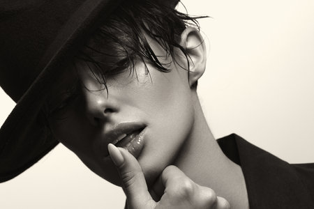 Monochrome close-up portrait of Young Woman in hat. Beautiful stylish Girlの写真素材