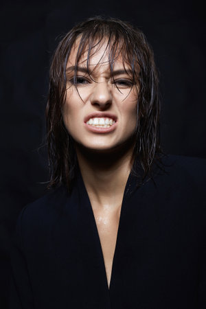 Funny young woman with Wet Hair. grimacing Beautiful girl portrait. Grimaceの写真素材
