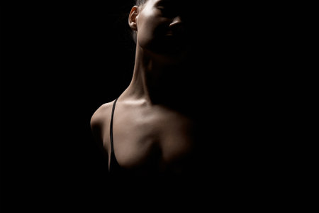 Female silhouette in dark. Beautiful passion Girl over black backgroundの写真素材