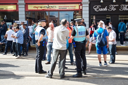 Sheffield, UK - June 8, 2013 - Police liason officers talking to the public at English Defence League and United Against Fascism protestのeditorial素材