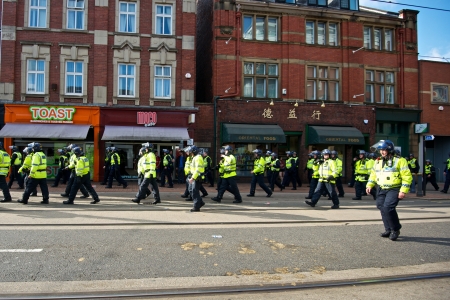 Sheffield, UK - June 8, 2013 - Police Inspector with riot policemen walking along West Street after English Defence League and United Against Fascism protestのeditorial素材