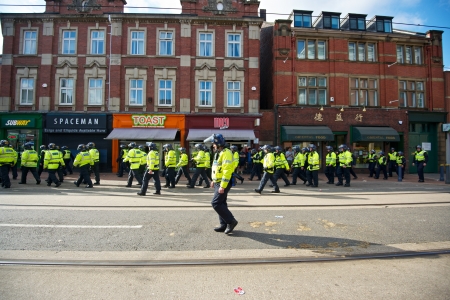 Sheffield, UK - June 8, 2013 - Police Inspector with riot policemen walking along West Street after English Defence League and United Against Fascism protestのeditorial素材