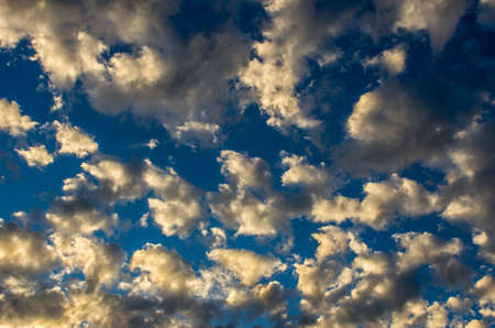 Dramatic sunset sky with golden clouds after thunderstorm