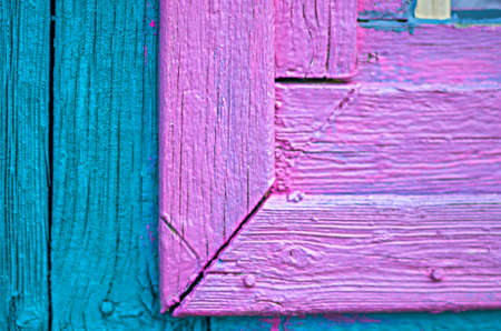 Details of an old painted wooden window frame and the wall of the guesthouse in the gardenの写真素材