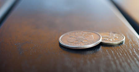Close view of a couple of coins on a street café tableの写真素材