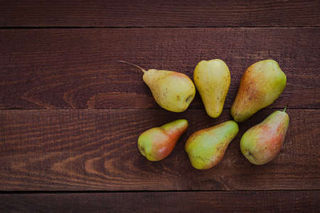 Ripe pears on rustic dark wooden table with copy spaceの写真素材