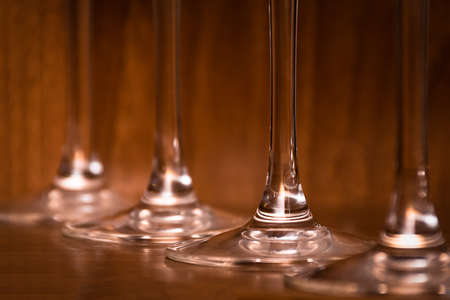 Catering, party concept: close-up image of wine glasses on a dark wooden background. Selective focus.の写真素材