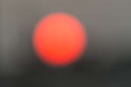Blurred And Defocused Image Of The Sun At Dawn In The City, Abstract Background With Copy Spaceの写真素材