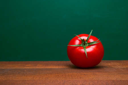 Whole Red Tomato On A Wooden Table. Green Background. Organic Food. Cooking Ingredients. Pomodoro...