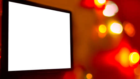 Blank White Screen Of A Digital Device, TV, Laptop, Smartphone, On Bright Vivid Background Of Blurred Colorful Lights.  Christmas, New Year, Seasonal Holidays Promo Message Mockupの写真素材